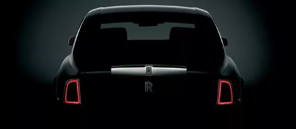 Rear of Rolls Royce Phantom limo with parking lights on.